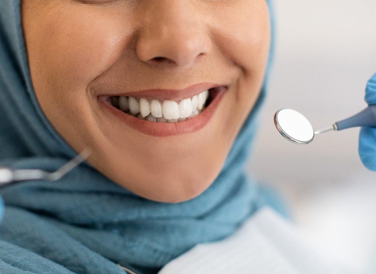 Smile Makeover. Closeup Shot Of Smiling Woman In Hijab During Dental Check Up In Modern Clinic, Cropped Image Of Muslim Female Patient Getting Treatment In Stomatologic Cabinet, Panorama