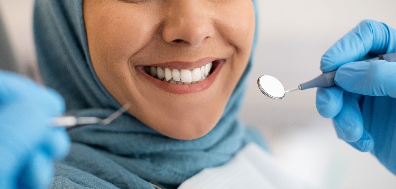 Smile Makeover. Closeup Shot Of Smiling Woman In Hijab During Dental Check Up In Modern Clinic, Cropped Image Of Muslim Female Patient Getting Treatment In Stomatologic Cabinet, Panorama